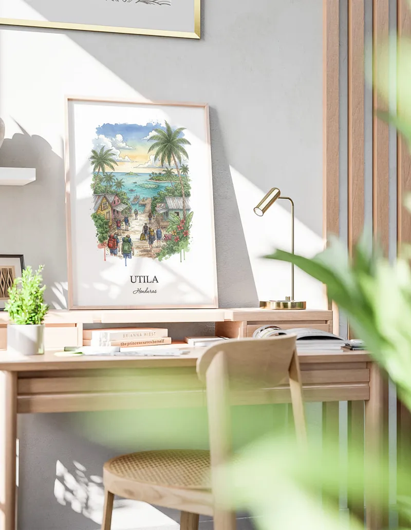 Framed wall art featuring Utila in Honduras in a light wood frame leaning on the floor.