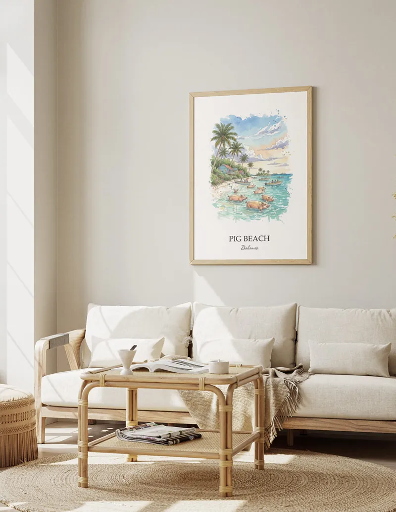 Cozy, well-lit workspace with a minimalist poster of Pig Beach, Bahamas in a light frame sitting on the desk.