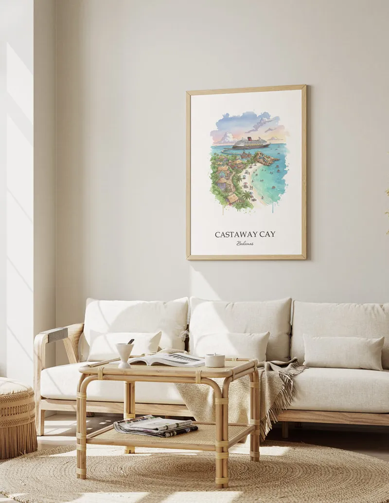 Cozy, well-lit workspace with a minimalist poster of Castaway Cay, Bahamas in a light frame sitting on the desk.