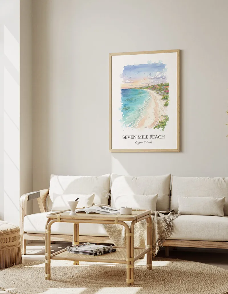 Cozy, well-lit workspace with a minimalist poster of Seven Mile Beach, Cayman Islands in a light frame sitting on the desk.