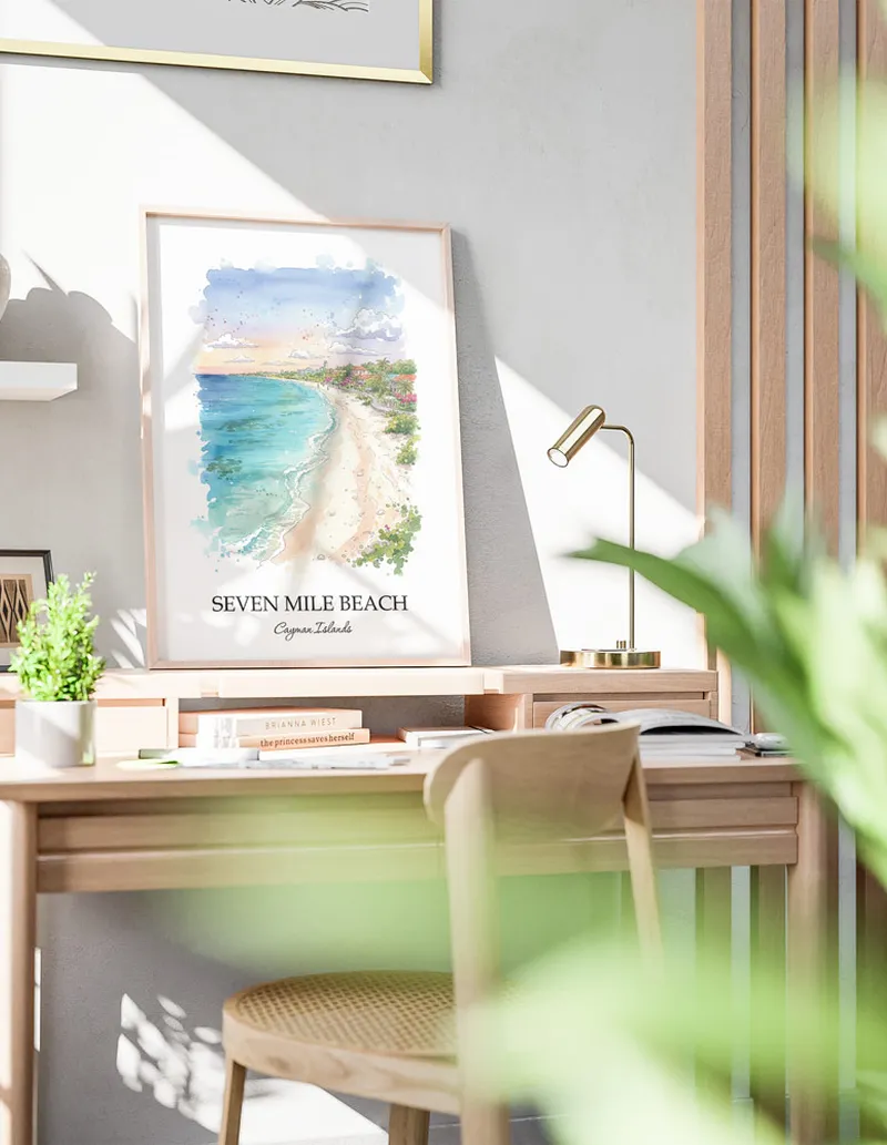 Framed wall art featuring Seven Mile Beach in Cayman Islands in a light wood frame leaning on the floor.