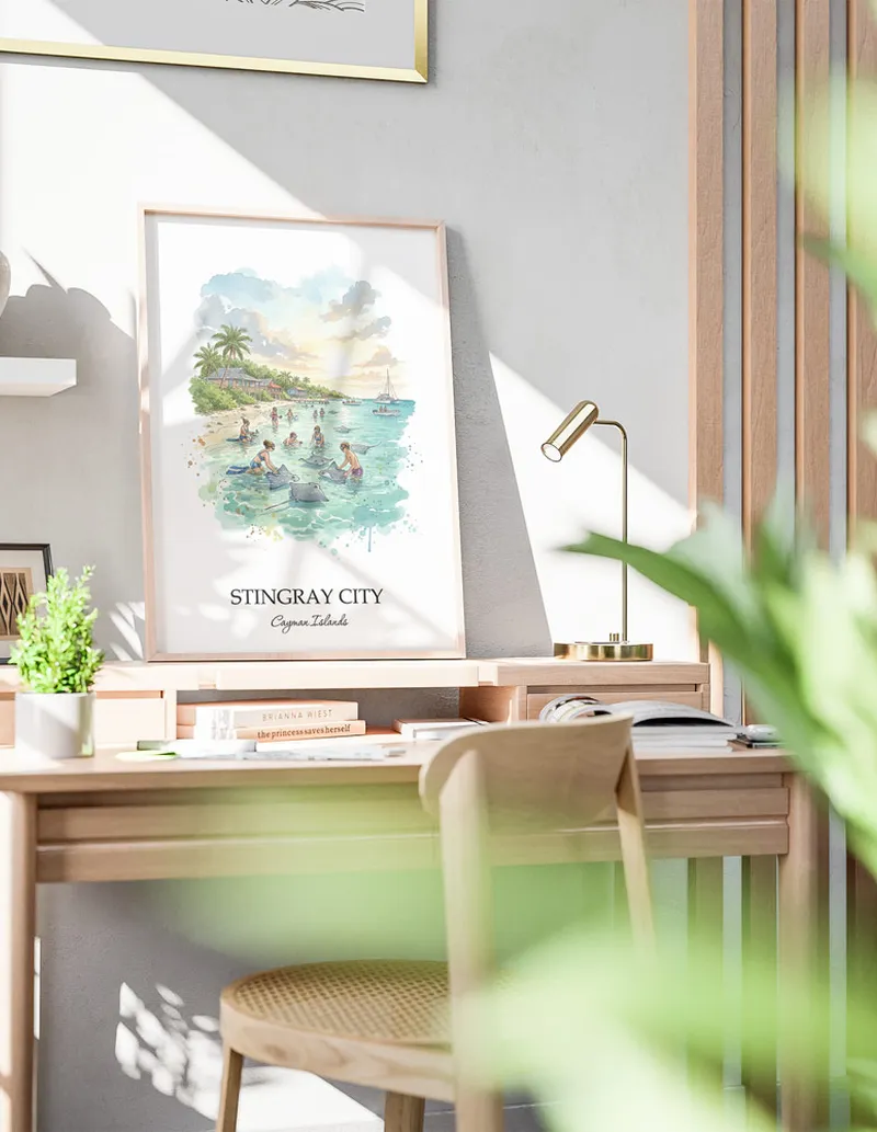 Framed wall art featuring Stingray City in Cayman Islands in a light wood frame leaning on the floor.