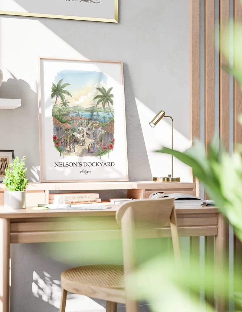Framed wall art featuring Nelson's Dockyard in Antigua in a light wood frame leaning on the floor.