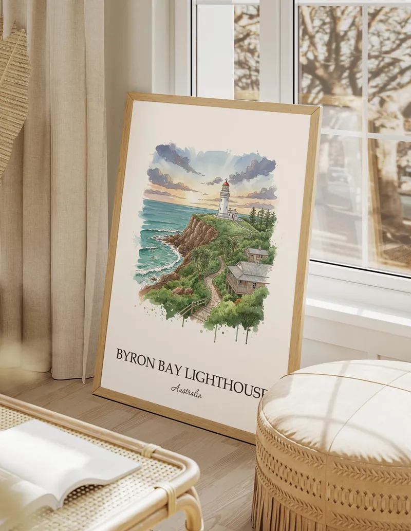 A gorgeous boho-inspired living space with a framed vintage travel poster of Byron Bay Lighthouse in Australia on display.