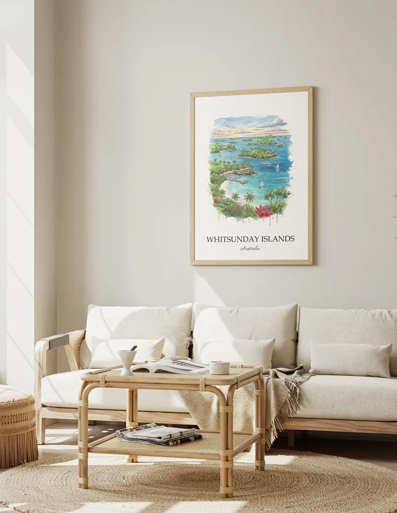 Cozy, well-lit workspace with a minimalist poster of Whitsunday Islands, Australia in a light frame sitting on the desk.