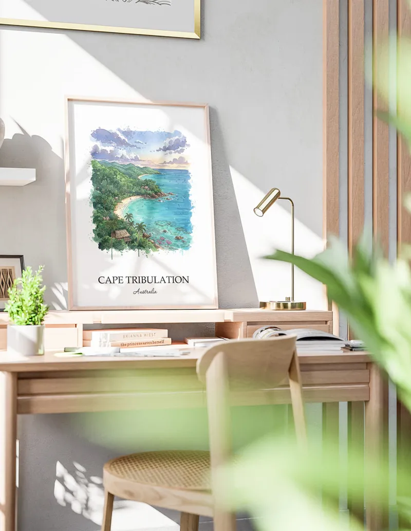 Framed wall art featuring Cape Tribulation in Australia in a light wood frame leaning on the floor.