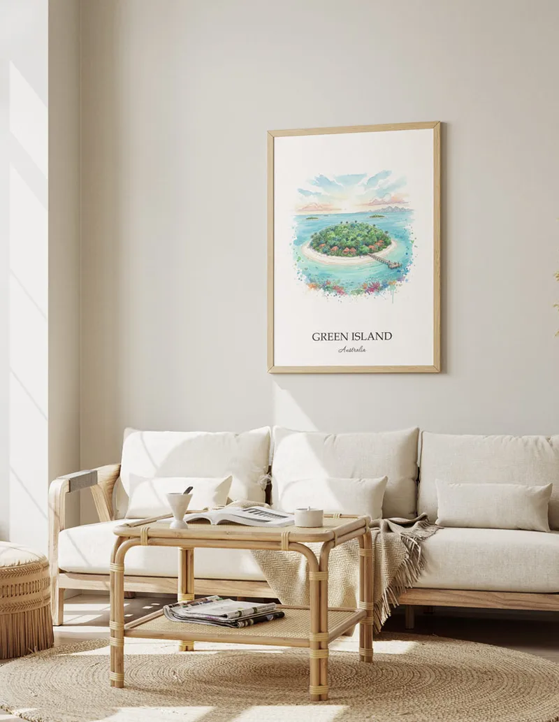 Cozy, well-lit workspace with a minimalist poster of Green Island, Australia in a light frame sitting on the desk.