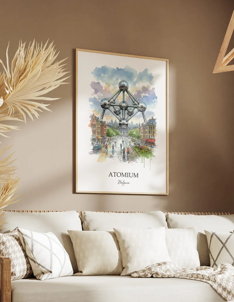 Vintage travel poster of Atomium, Belgium in a light frame displayed above a sofa in a bright boho interior.