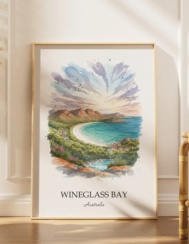 Framed wall art featuring Wineglass Bay, Australia in a light wood frame hanging above a sofa in a modern living room.