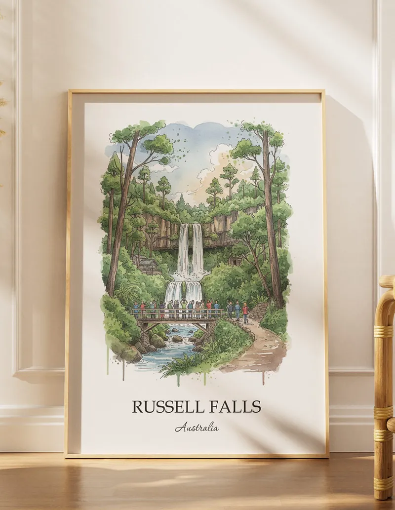 Framed wall art featuring Russell Falls, Australia in a light wood frame hanging above a sofa in a modern living room.