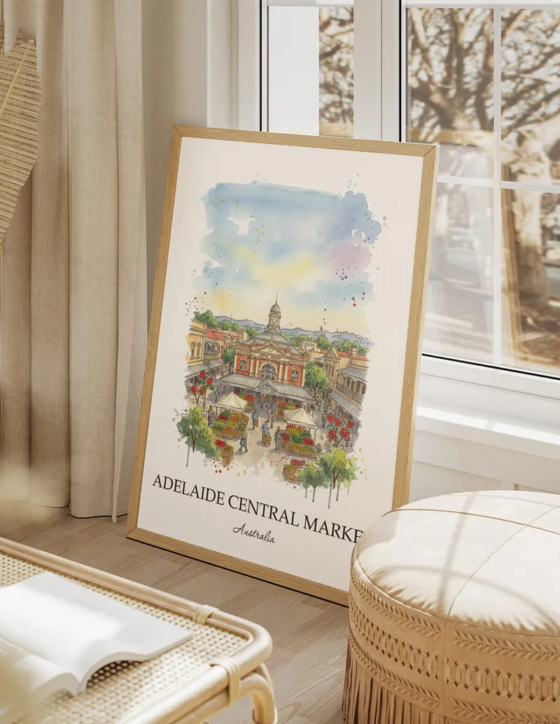 Cozy, well-lit workspace with a minimalist poster of Adelaide Central Market, Australia in a light frame sitting on the desk.