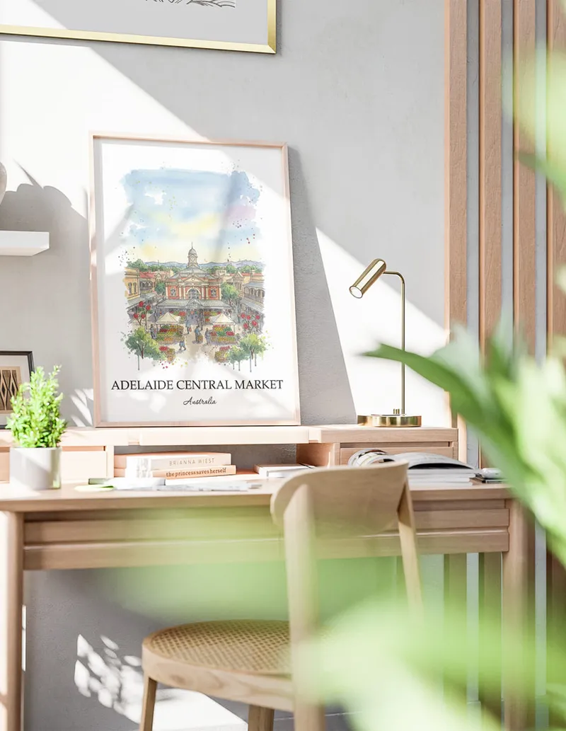 Minimalist poster of Adelaide Central Market in Australia in a light frame standing on the floor in a dark moody interior.