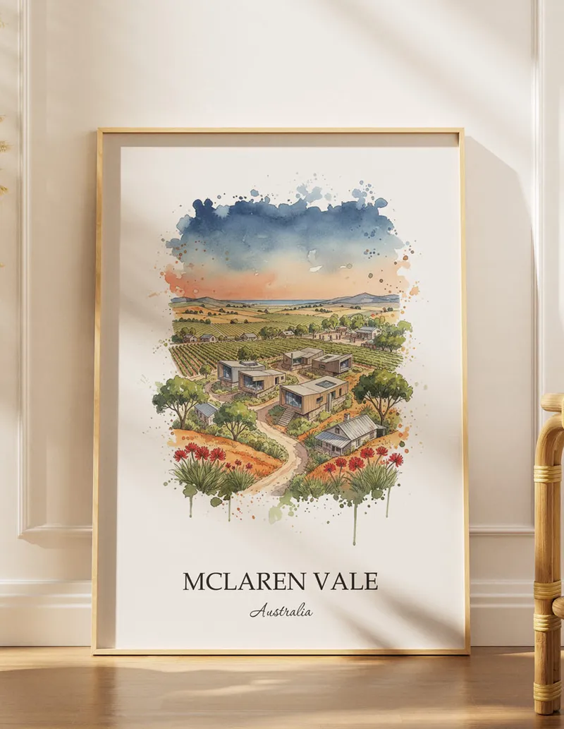 Framed wall art featuring McLaren Vale, Australia in a light wood frame hanging above a sofa in a modern living room.