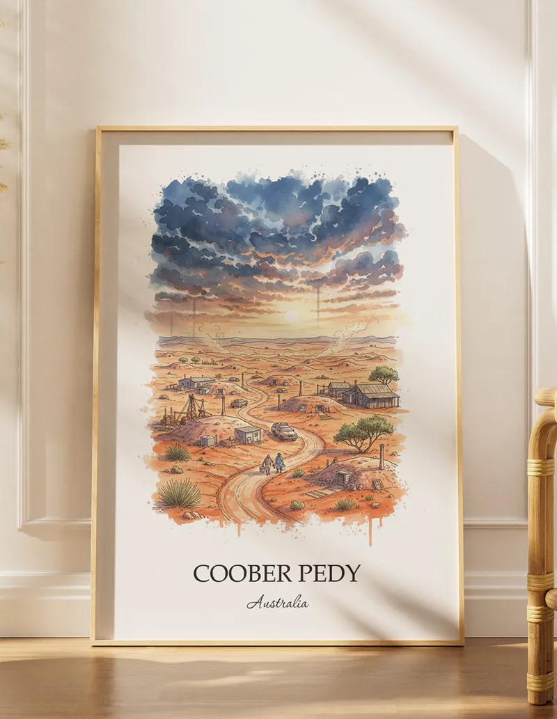 Framed wall art featuring Coober Pedy, Australia in a light wood frame hanging above a sofa in a modern living room.