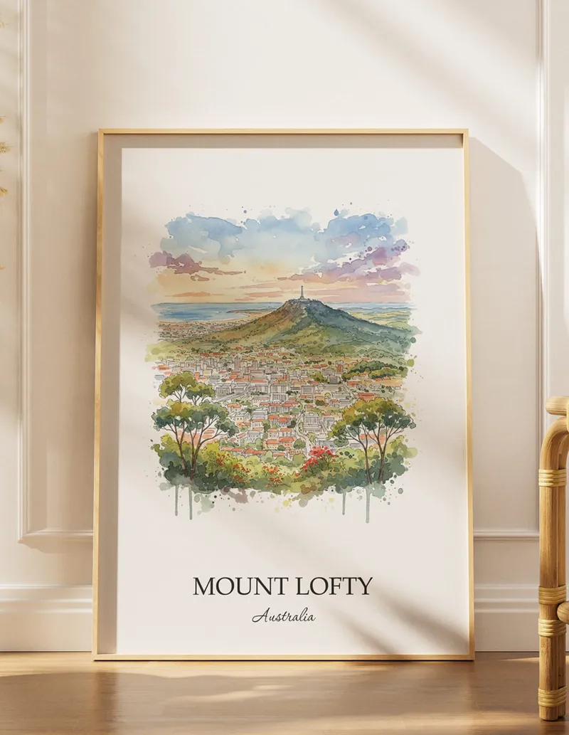 Framed wall art featuring Mount Lofty, Australia in a light wood frame hanging above a sofa in a modern living room.