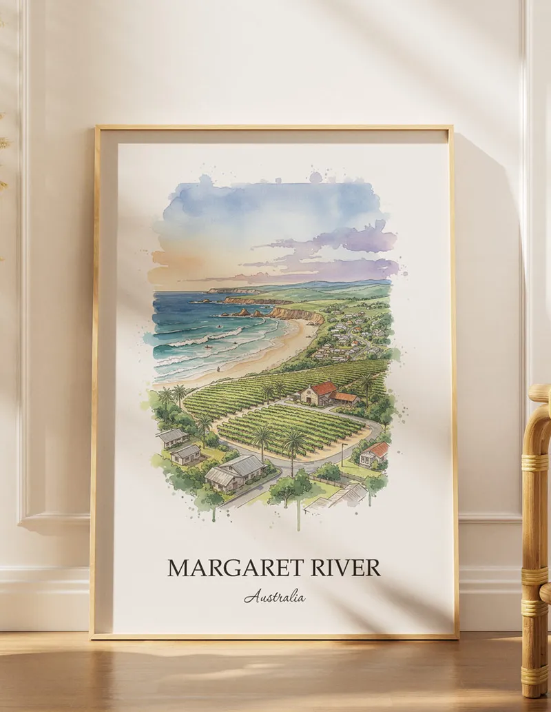 Framed wall art featuring Margaret River, Australia in a light wood frame hanging above a sofa in a modern living room.