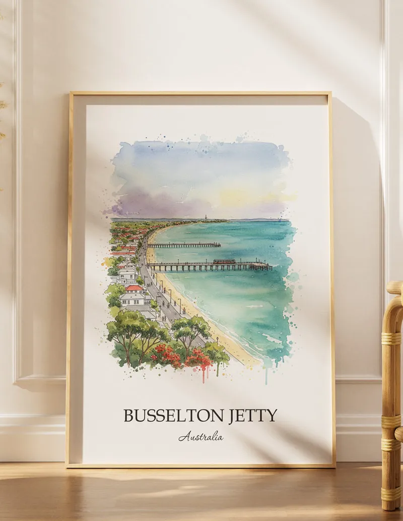 Framed wall art featuring Busselton Jetty, Australia in a light wood frame hanging above a sofa in a modern living room.