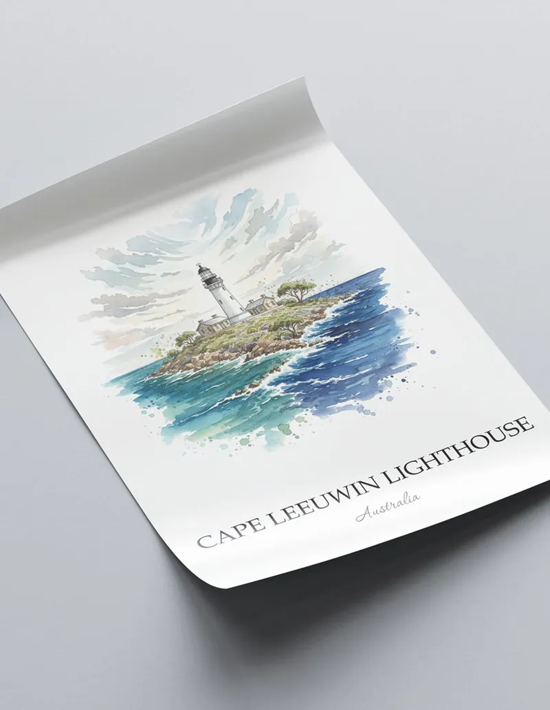 Framed wall art featuring Cape Leeuwin Lighthouse, Australia in a light wood frame hanging above a sofa in a modern living room.