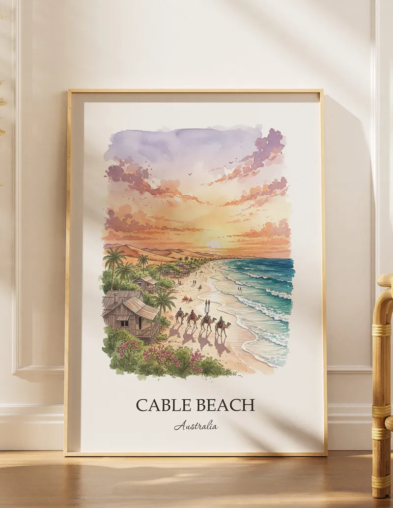 Vintage travel poster of Cable Beach, Australia in a light frame displayed above a sofa in a bright boho interior.