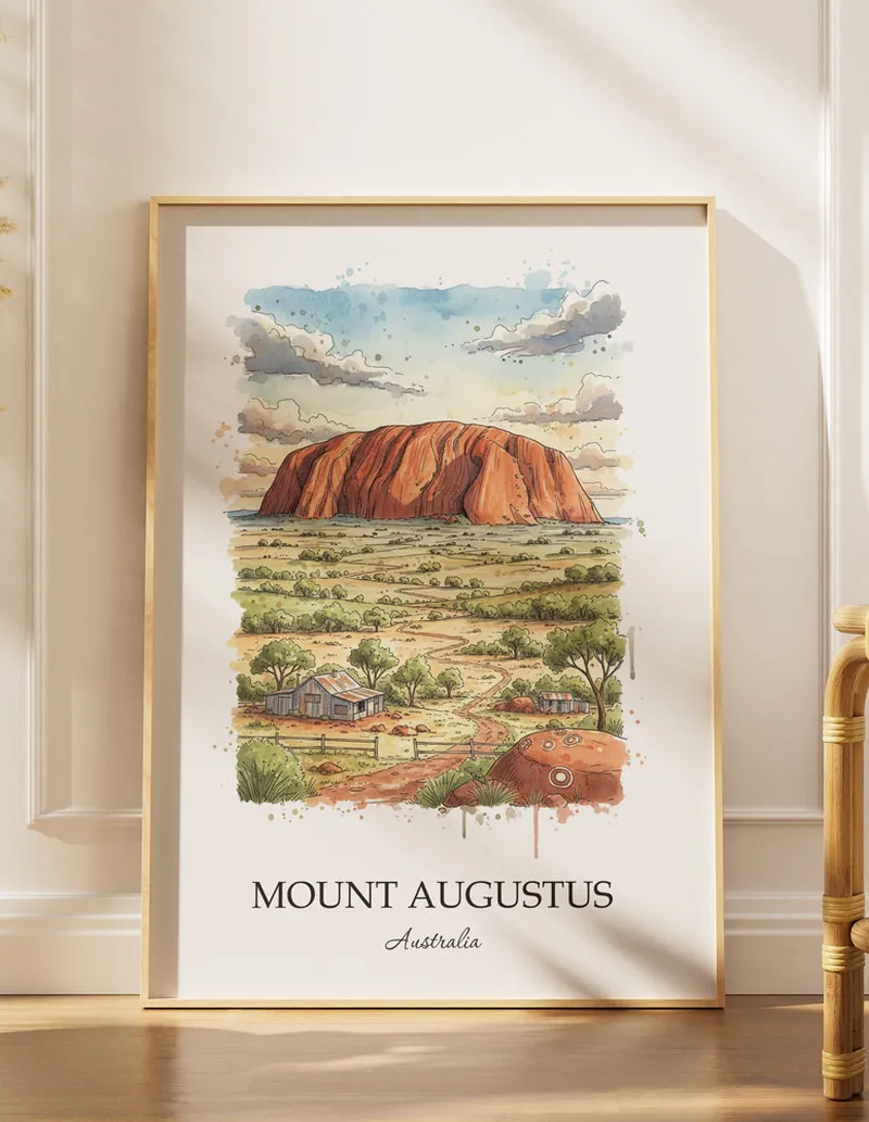 Vintage travel poster of Mount Augustus, Australia in a light frame displayed above a sofa in a bright boho interior.