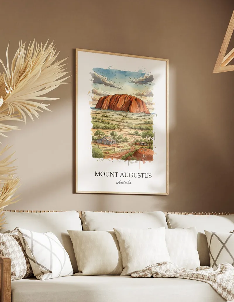 Framed wall art featuring Mount Augustus in Australia in a light wood frame leaning on the floor.