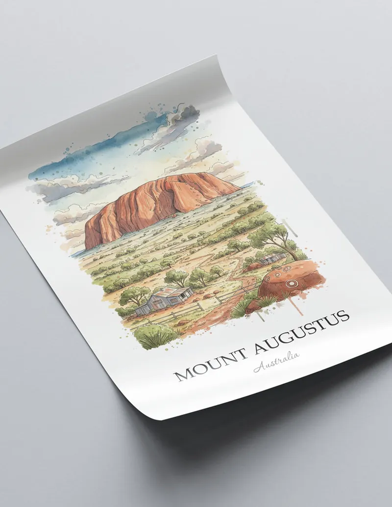 Framed wall art featuring Mount Augustus, Australia in a light wood frame hanging above a sofa in a modern living room.