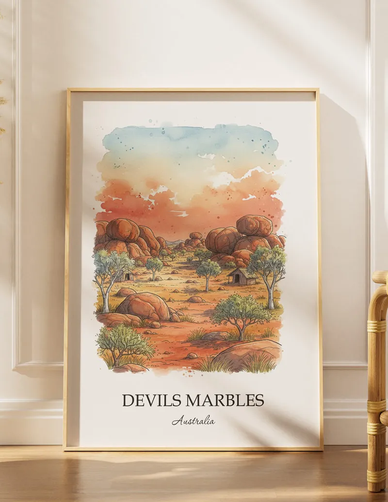 Vintage travel poster of Devils Marbles, Australia in a light frame displayed above a sofa in a bright boho interior.
