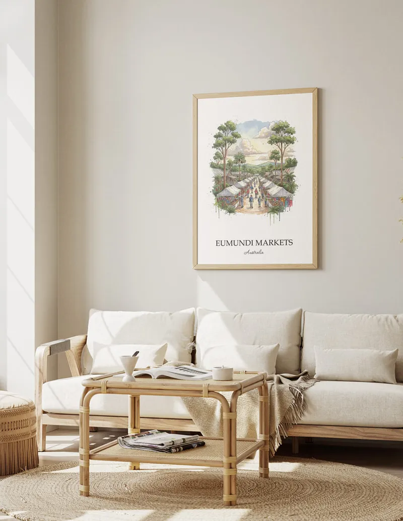 Framed wall art featuring Eumundi Markets in Australia in a light wood frame leaning on the floor.