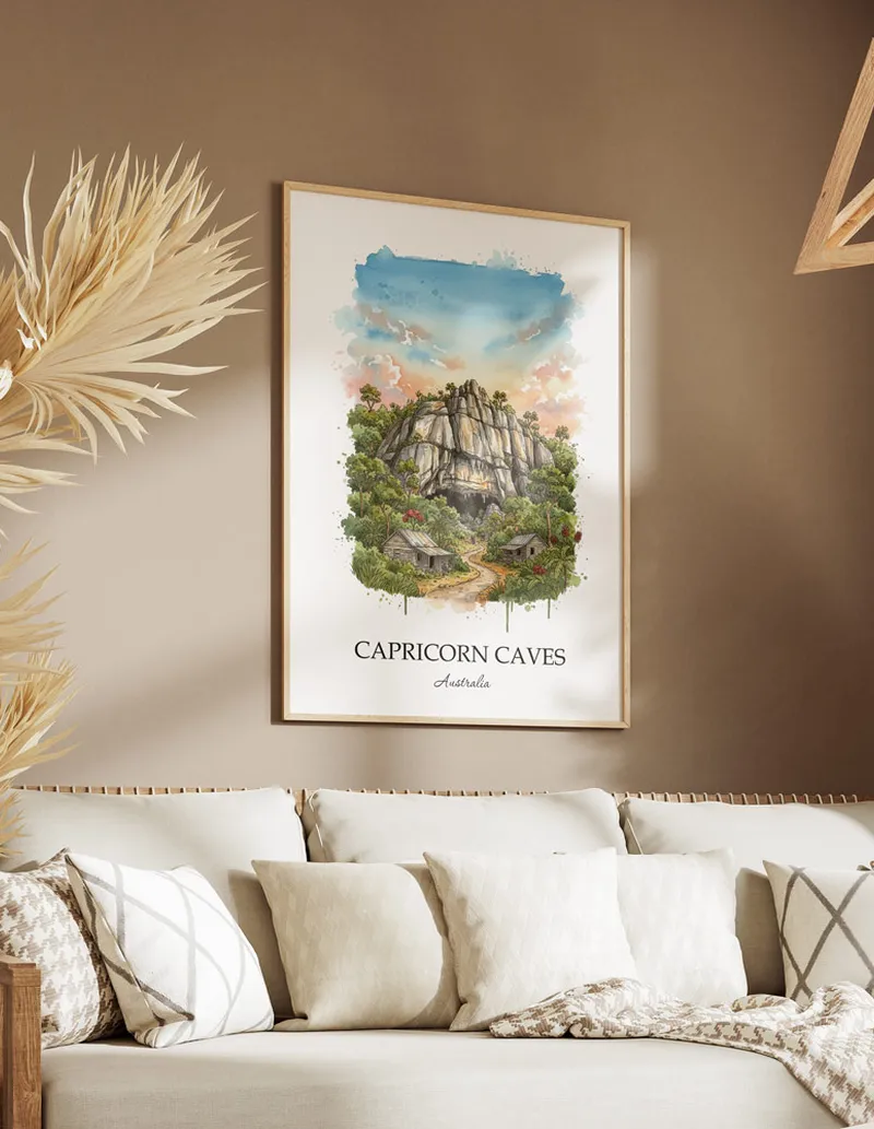 Minimalist poster of Capricorn Caves in Australia in a light frame standing on the floor in a dark moody interior.