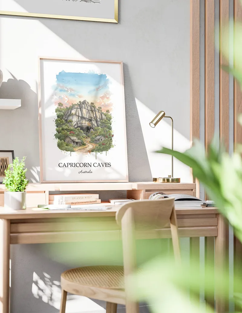 Minimalist poster of Capricorn Caves in Australia in a light frame standing by a window in a boho style room.