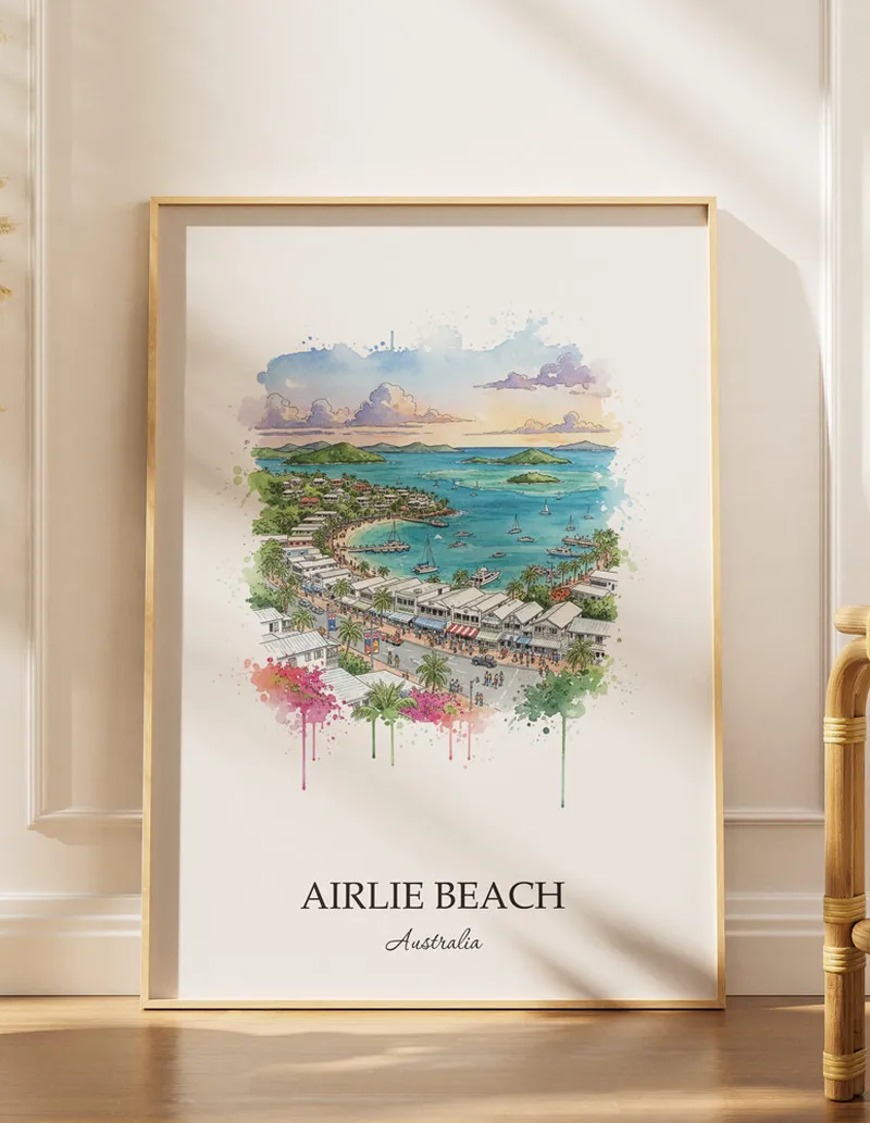 A gorgeous boho-inspired living space with a framed vintage travel poster of Airlie Beach in Australia on display.