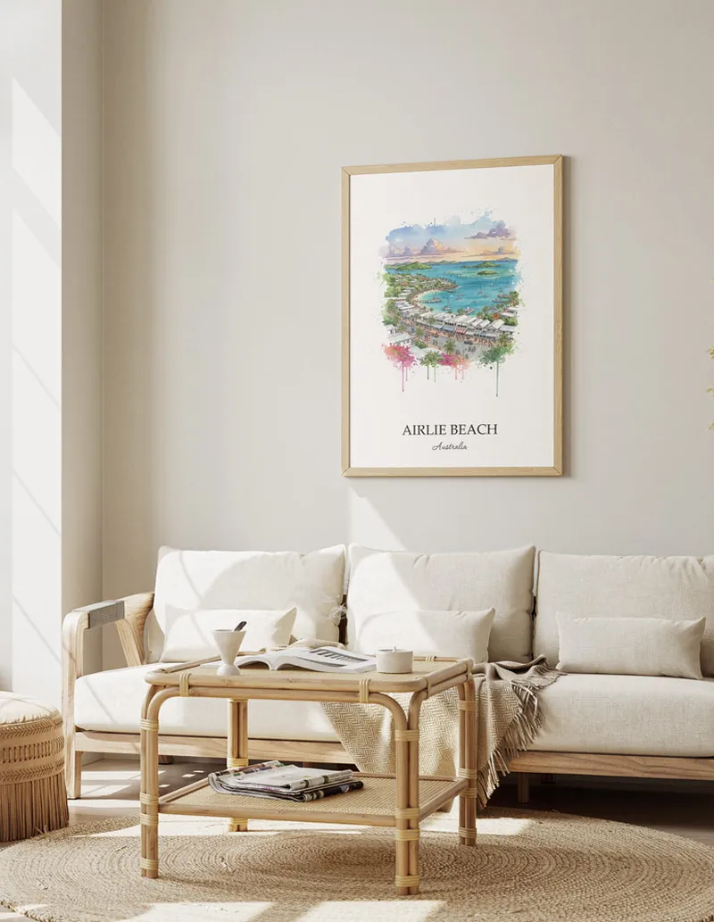 Framed wall art featuring Airlie Beach in Australia in a light wood frame leaning on the floor.