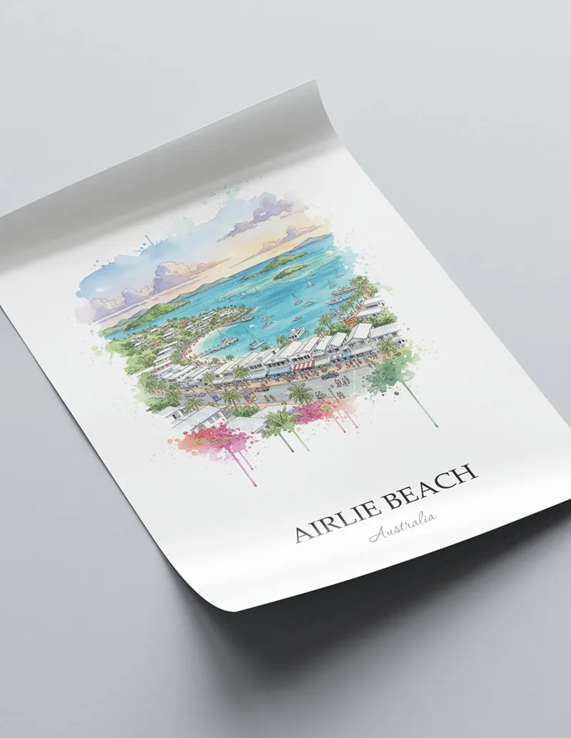 Vintage travel poster of Airlie Beach, Australia in a light frame displayed above a sofa in a bright boho interior.