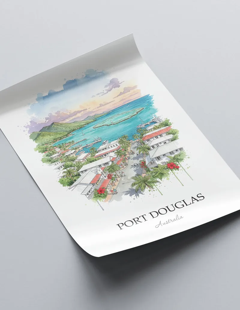 Vintage travel poster of Port Douglas, Australia in a light frame displayed above a sofa in a bright boho interior.