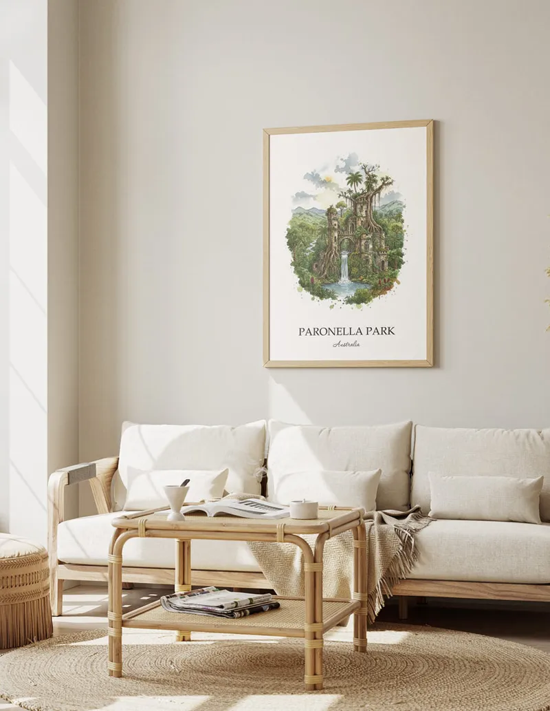 Framed wall art featuring Paronella Park in Australia in a light wood frame leaning on the floor.