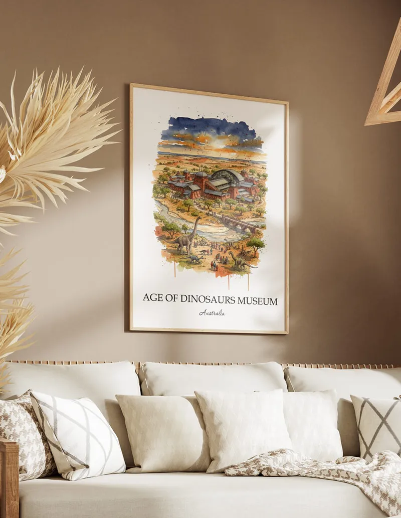 Minimalist poster of Age of Dinosaurs Museum in Australia in a light frame standing on the floor in a dark moody interior.