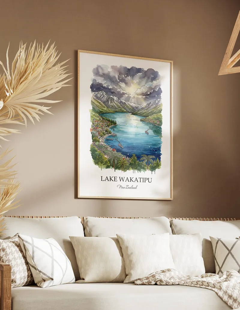Minimalist poster of Lake Wakatipu in New Zealand in a light frame standing on the floor in a dark moody interior.