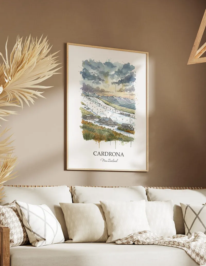 Minimalist poster of Cardrona in New Zealand in a light frame standing on the floor in a dark moody interior.