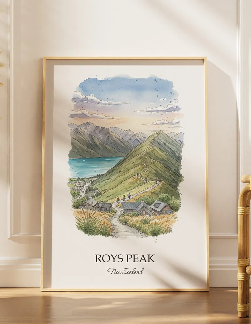 A gorgeous boho-inspired living space with a framed vintage travel poster of Roys Peak in New Zealand on display.