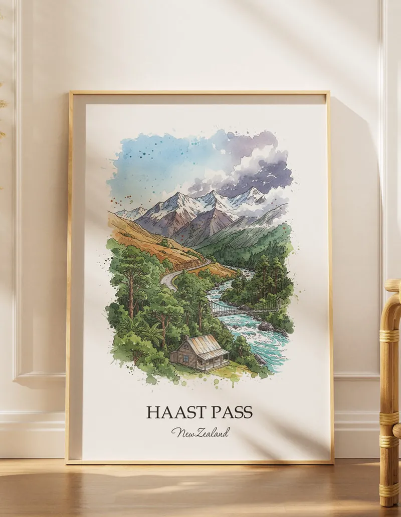 A gorgeous boho-inspired living space with a framed vintage travel poster of Haast Pass in New Zealand on display.