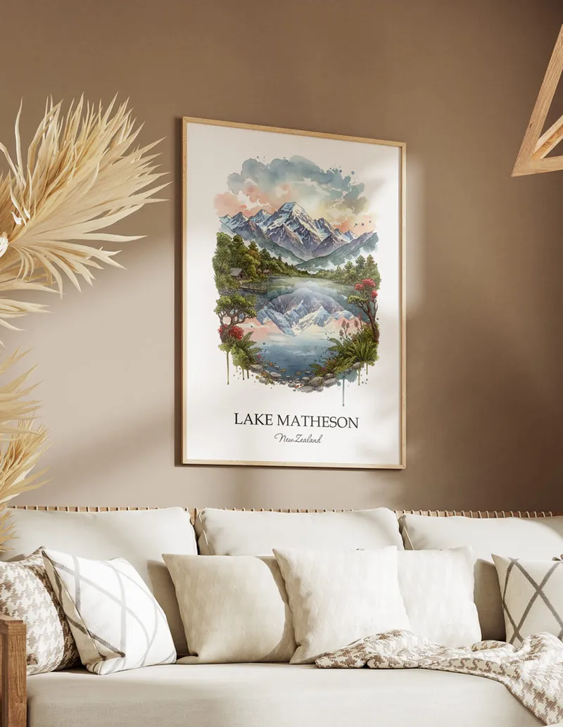 Minimalist poster of Lake Matheson in New Zealand in a light frame standing on the floor in a dark moody interior.