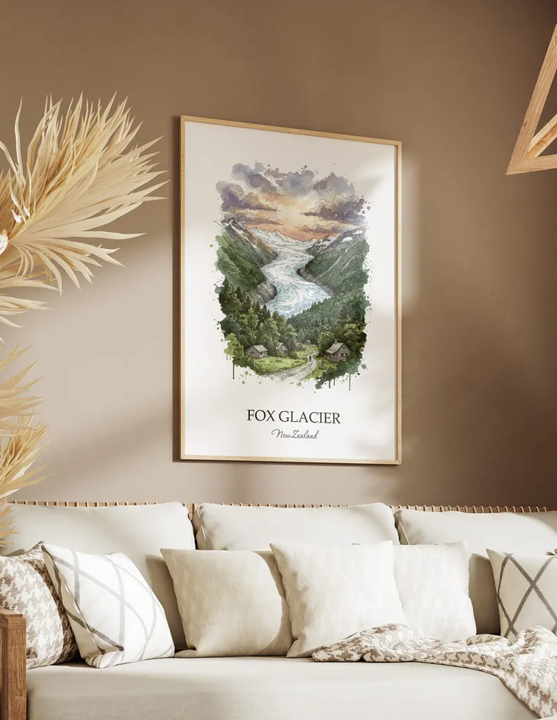 Minimalist poster of Fox Glacier in New Zealand in a light frame standing on the floor in a dark moody interior.