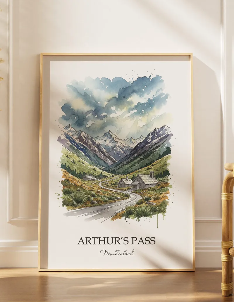 A gorgeous boho-inspired living space with a framed vintage travel poster of Arthur's Pass in New Zealand on display.