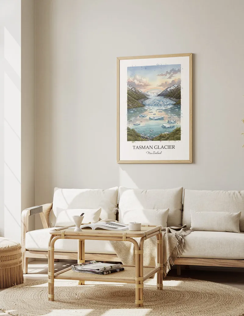 Framed wall art featuring Tasman Glacier in New Zealand in a light wood frame leaning on the floor.