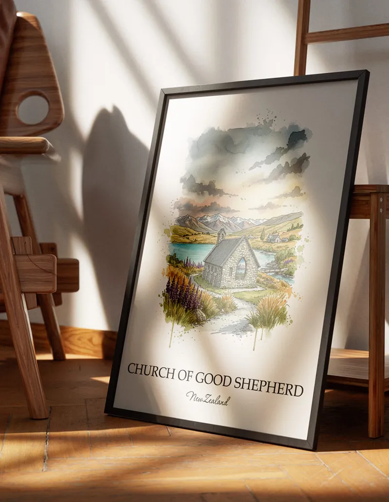 Cozy, well-lit workspace with a minimalist poster of Church of Good Shepherd, New Zealand in a light frame sitting on the desk.