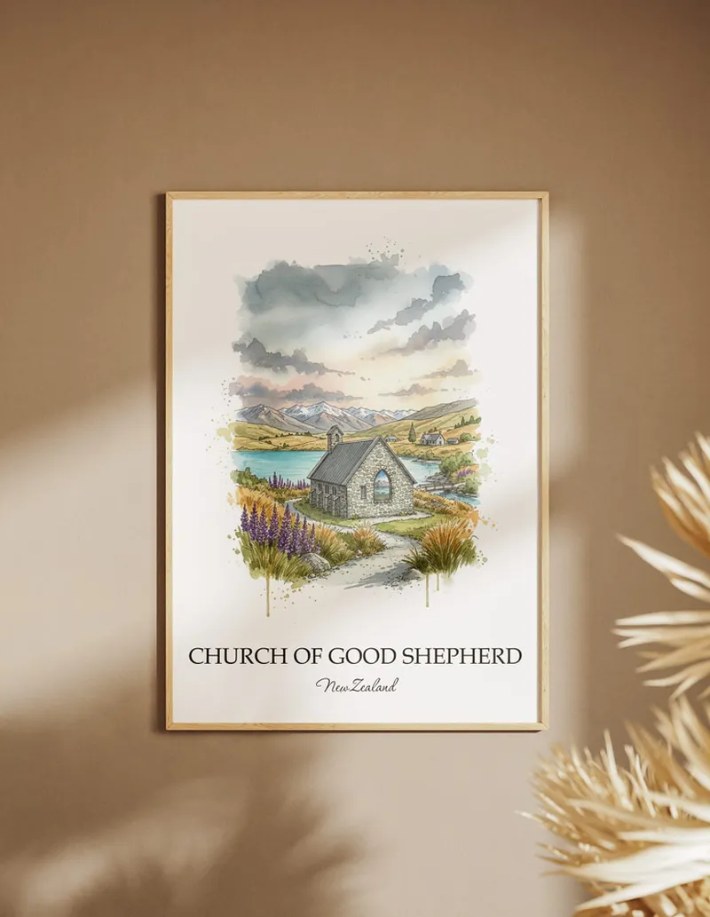 Framed wall art featuring Church of Good Shepherd, New Zealand in a light wood frame hanging above a sofa in a modern living room.