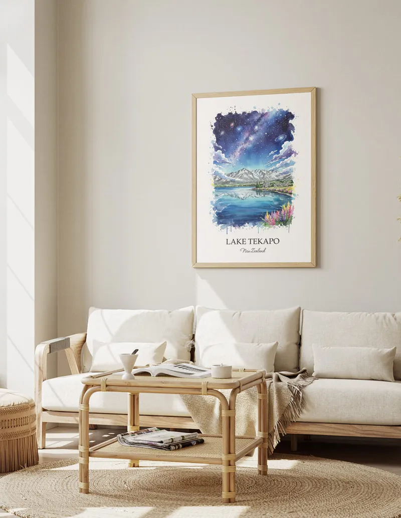 Framed wall art featuring Lake Tekapo in New Zealand in a light wood frame leaning on the floor.