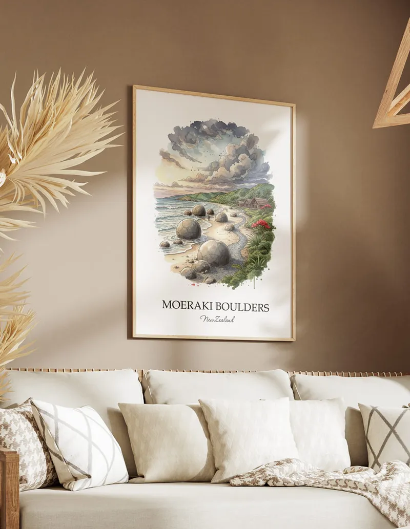 Minimalist poster of Moeraki Boulders in New Zealand in a light frame standing on the floor in a dark moody interior.