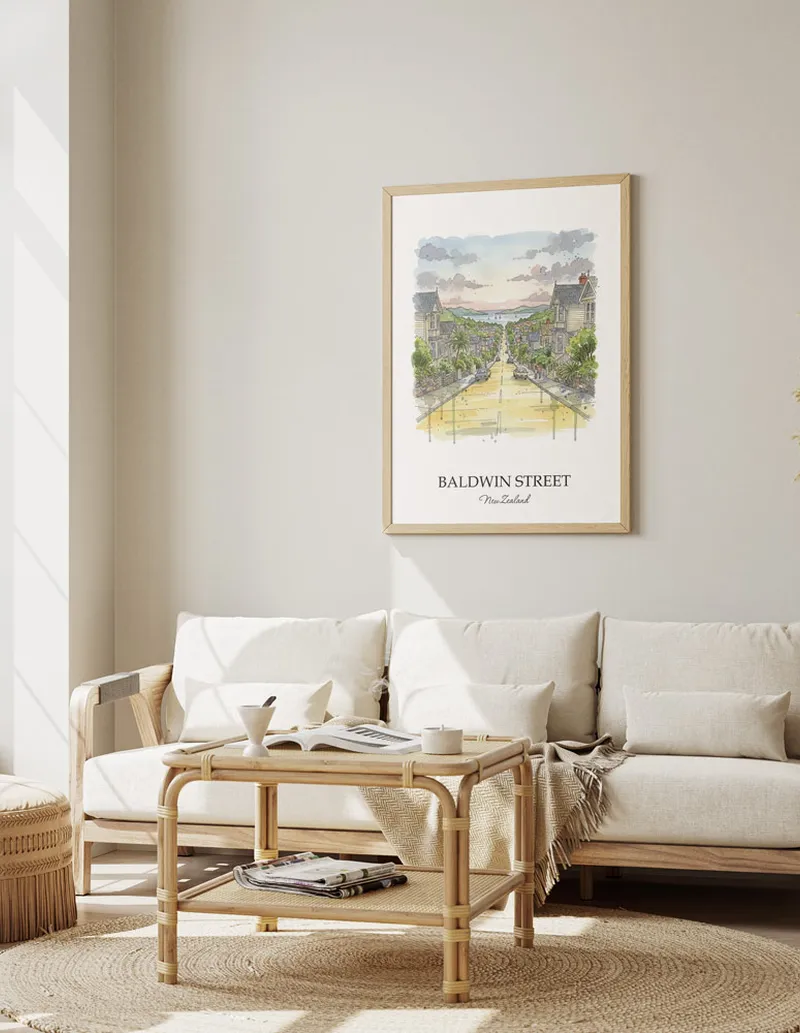 Framed wall art featuring Baldwin Street in New Zealand in a light wood frame leaning on the floor.