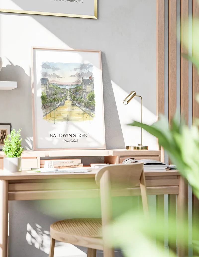 Minimalist poster of Baldwin Street in New Zealand in a light frame standing by a window in a boho style room.